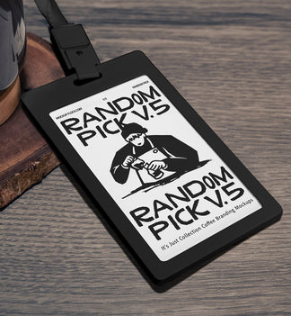 Black plastic ID card badge with green lanyard lying at an angle on a rustic wooden table next to a coffee mug and wood coaster, perfect for cafe staff badge branding mockup