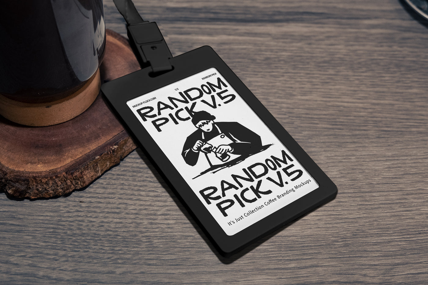 Black plastic ID card badge with green lanyard lying at an angle on a rustic wooden table next to a coffee mug and wood coaster, perfect for cafe staff badge branding mockup
