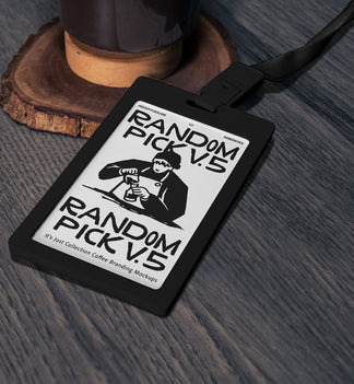 Black ID badge card with dark green lanyard lying flat on a textured wooden surface next to a coffee grinder base, top angle flat lay mockup for cafe branding