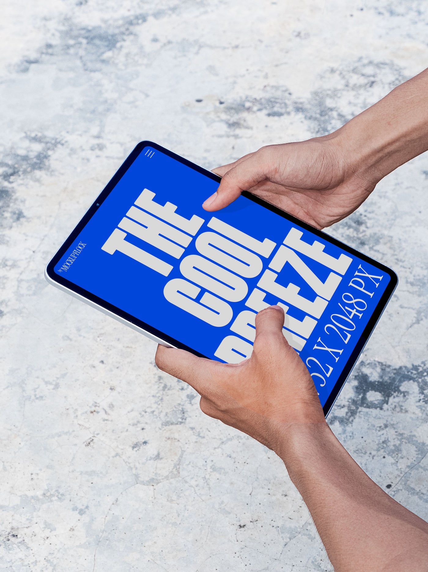 A person is holding an ipad labeled "THE COOL BREEZE 2732X2048 PX" in bold white text. Design by Mockup Flock