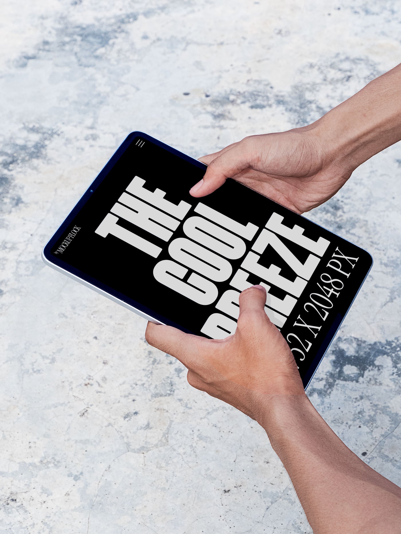 A person is holding an ipad labeled "THE COOL BREEZE 2732X2048 PX" in bold white text. Design by Mockup Flock
