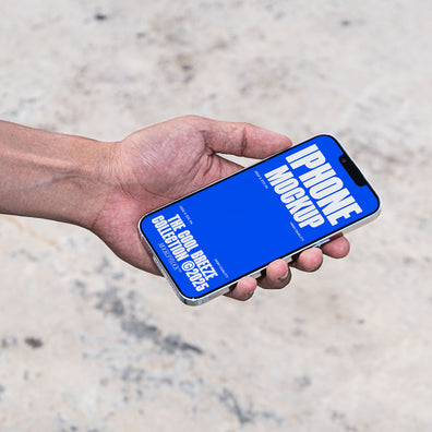 A person is holding an iPhone that says "IPHONE MOCKUP THE COOL BREEZE COLLECTION @2025" in bold white text. Design by Mockup Flock