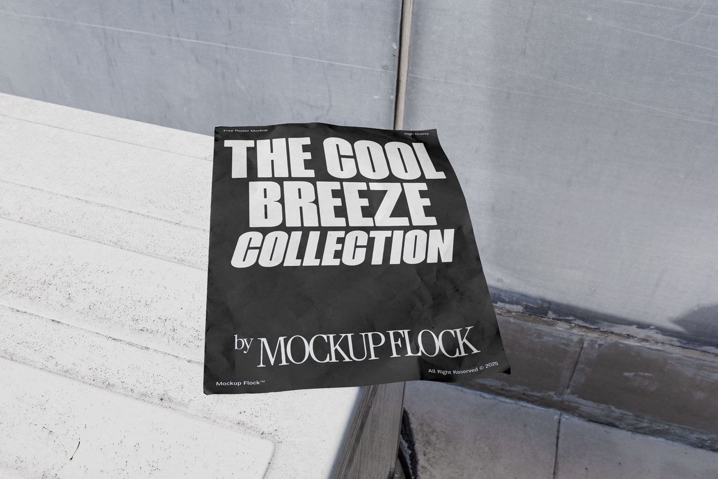 A black Poster with white text reading THE COOL BREEZE COLLECTION BY MOCKUP FLOCK is lying on a box white, displayed in a outdoor setting.
