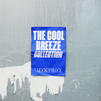 A vertical blue poster mockup on a wall peeling off its paint in natural lighting, revealing a blank white surface with a paper texture. Design by Mockup Flock