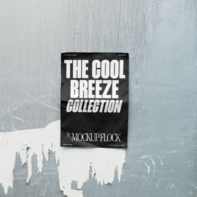 A vertical black poster mockup on a wall peeling off its paint in natural lighting, revealing a blank white surface with a paper texture. Design by Mockup Flock