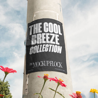 Vertical poster mounted on a pole with natural lighting, surrounded by red and yellow flowers against a blue sky.