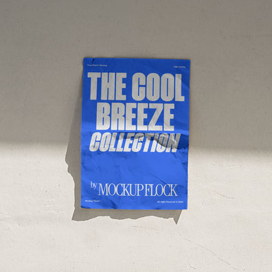 A vertical blue poster mockup stick on the wall, with a crumpled paper texture, on a shaded background, on a shaded background. Design by Mockup Flock