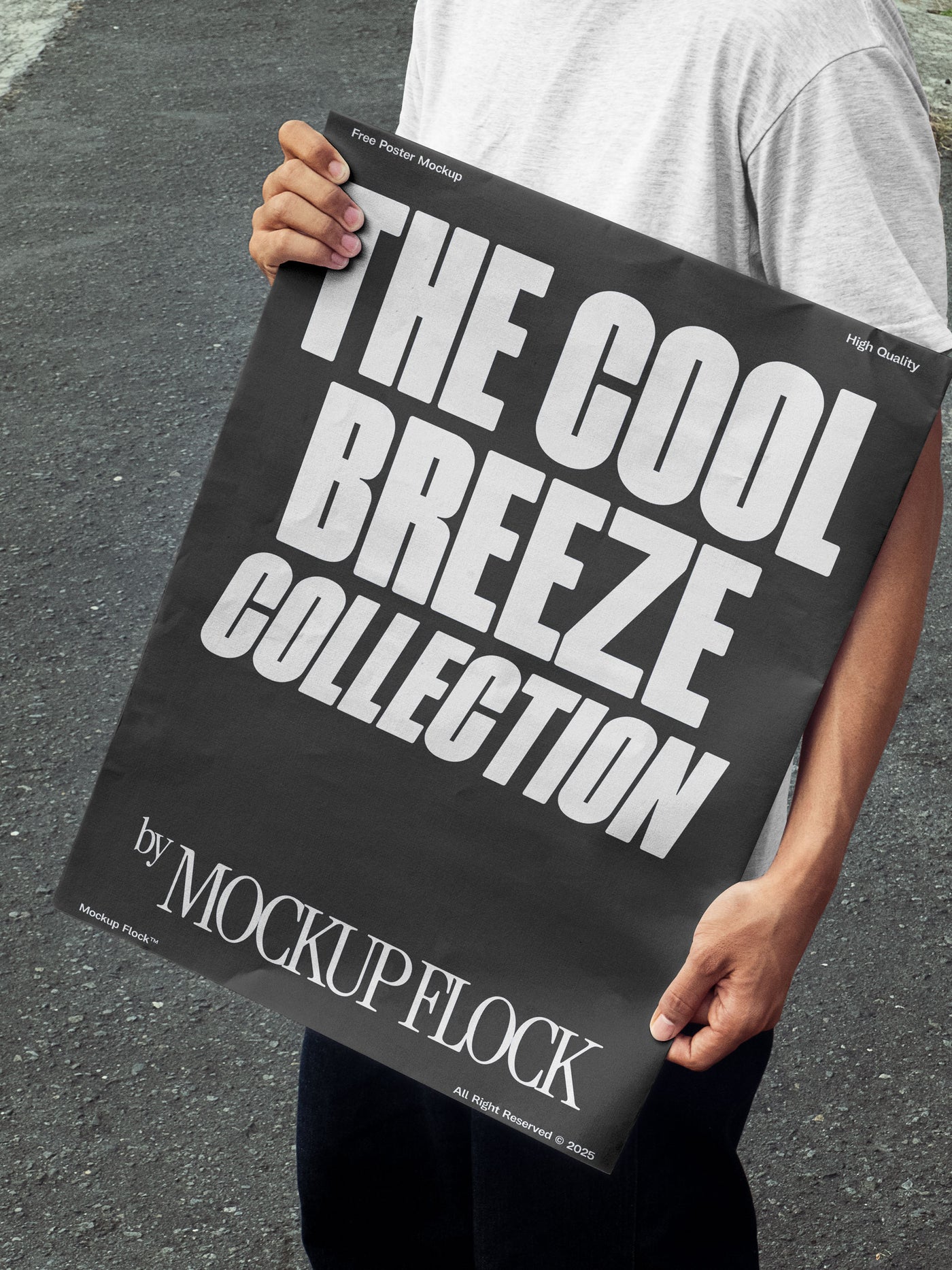 A person holds a poster that reads "THE COOL BREEZE COLLECTION BY MOCKUP FLOCK" in bold text, standing on black asphalt.