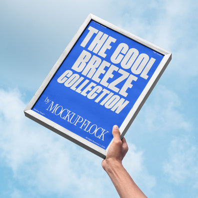 A person holds a poster that says "THE COOL BREEZE COLLECTION BY MOCKUP FLOCK" in bold text, on a blue sky background.