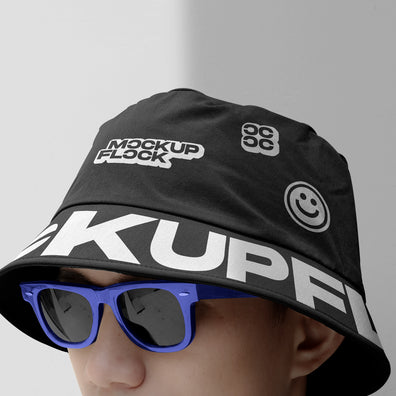 A person wearing a bucket hat and blue glasses, written MOCKUP FLOCK