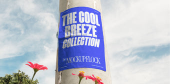 Vertical poster mounted on a pole with natural lighting, surrounded by red and yellow flowers against a blue sky.
