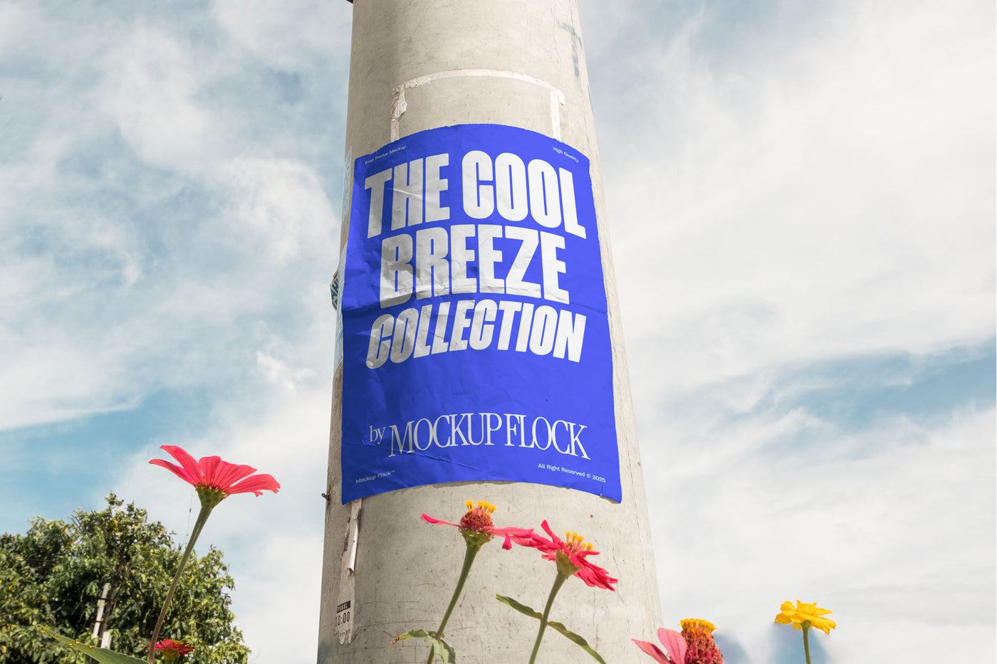 Vertical poster mounted on a pole with natural lighting, surrounded by red and yellow flowers against a blue sky.