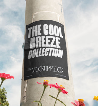 Vertical poster mounted on a pole with natural lighting, surrounded by red and yellow flowers against a blue sky.