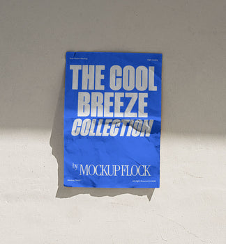 A vertical blue poster mockup stick on the wall, with a crumpled paper texture, on a shaded background, on a shaded background. Design by Mockup Flock