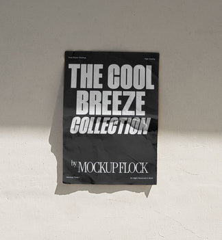 A vertical black poster mockup stick on the wall, with a crumpled paper texture, on a shaded background, on a shaded background. Design by Mockup Flock