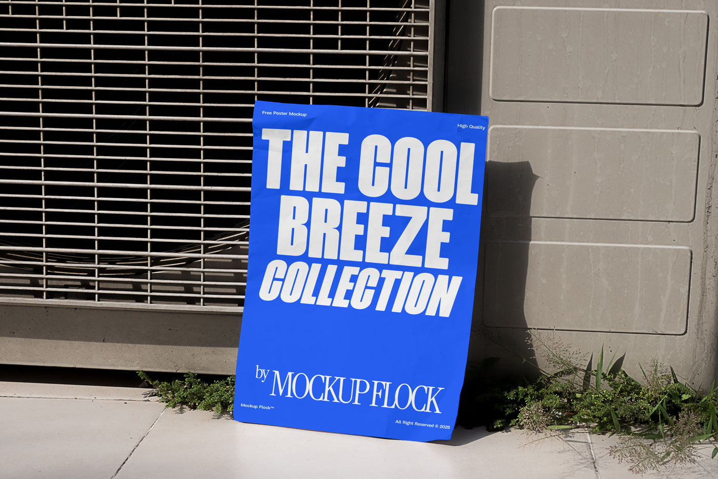 A blue Poster with white text reading THE COOL BREEZE COLLECTION BY MOCKUP FLOCK is lying on the grassy floor, attached to the outdoor air conditioner.