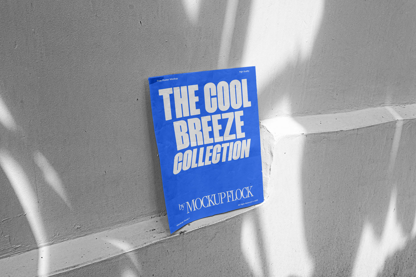 A blue poster with white text reading THE COOL BREEZE COLLECTION BY MOCKUP FLOCK, against the wall.