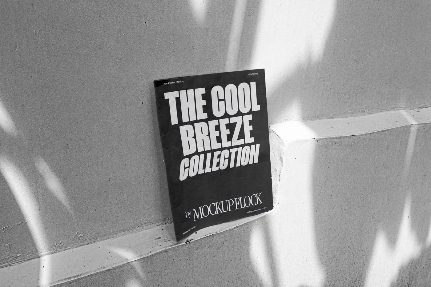 A black poster with white text reading THE COOL BREEZE COLLECTION BY MOCKUP FLOCK, against the wall.