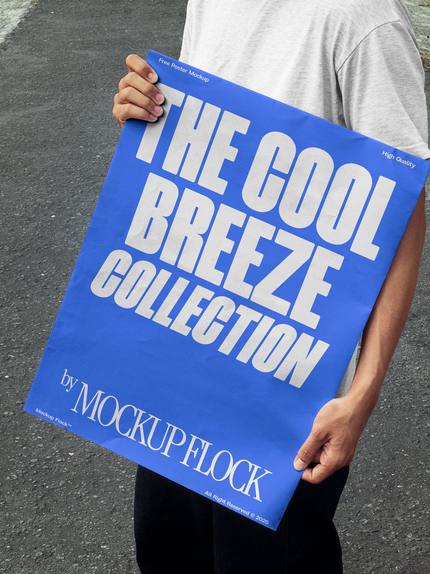 A person holds a poster that reads "THE COOL BREEZE COLLECTION BY MOCKUP FLOCK" in bold text, standing on black asphalt.