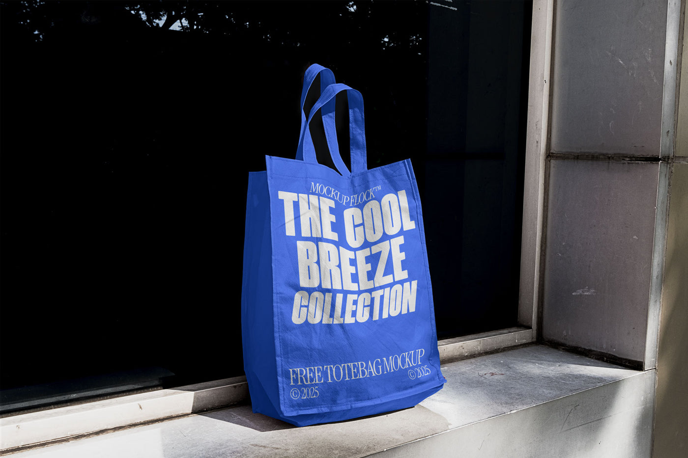 A blue poster with white text reading THE COOL BREEZE COLLECTION BY MOCKUP FLOCK, is stuck to the window.