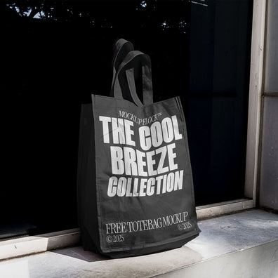 A black poster with white text reading THE COOL BREEZE COLLECTION BY MOCKUP FLOCK, is stuck to the window.