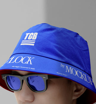 A person wearing a bucket hat and blue glasses, written TCB and MOCKUP FLOCK.