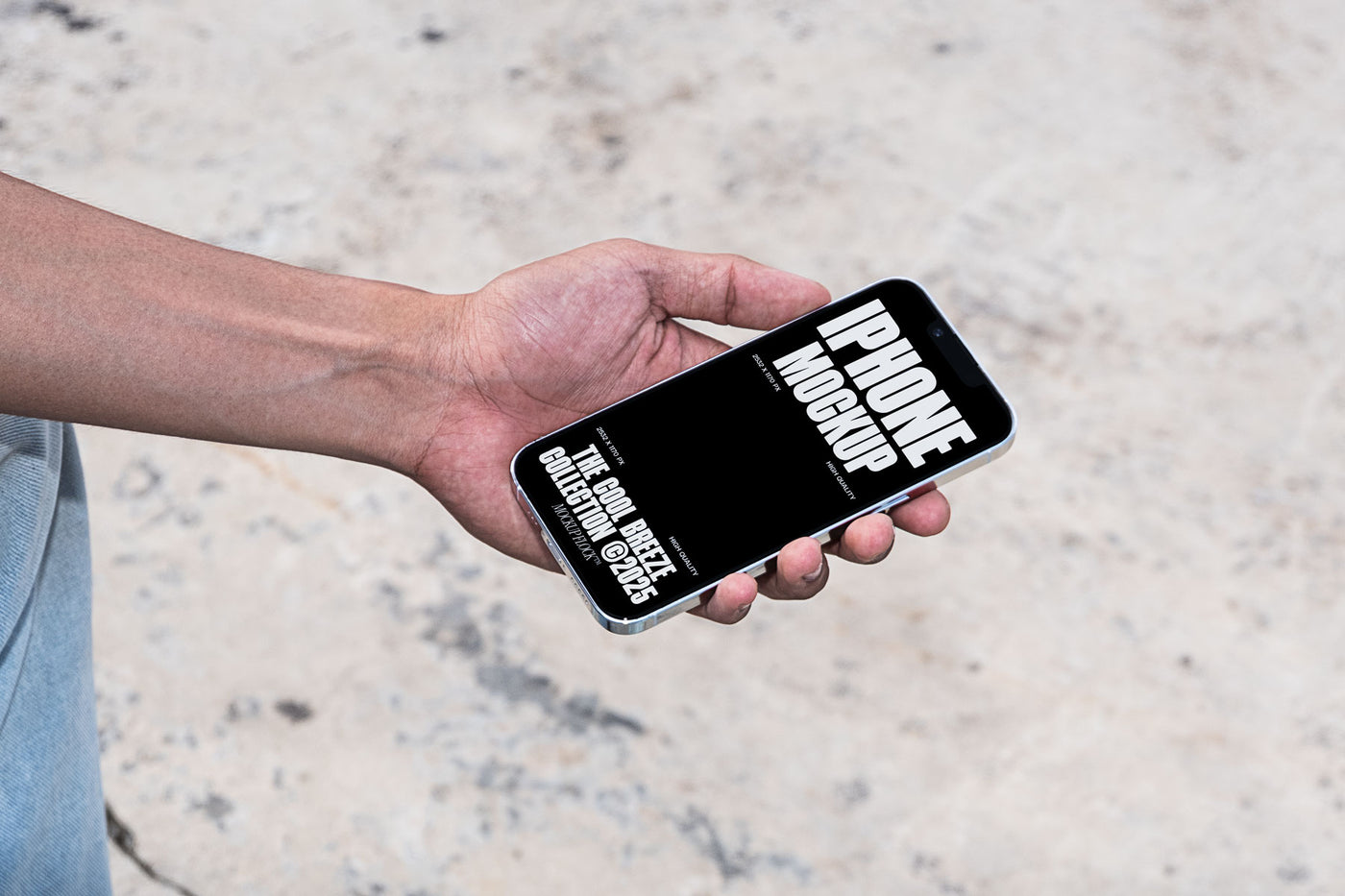 A person is holding an iPhone that says "IPHONE MOCKUP THE COOL BREEZE COLLECTION @2025" in bold white text. Design by Mockup Flock