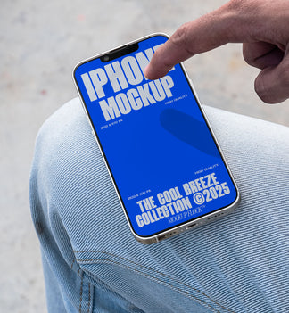 A person is touching an iPhone that says "IPHONE MOCKUP THE COOL BREEZE COLLECTION @2025" in bold white text. Design by Mockup Flock