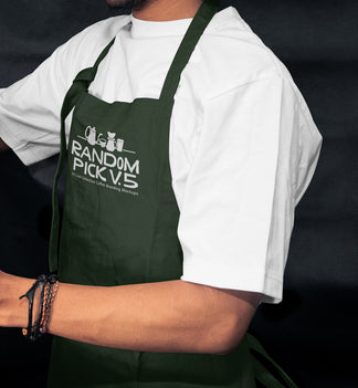 Side view of a barista wearing a dark green apron leaning against a metal shelf in a moody cafe environment, ideal for staff uniform branding mockup