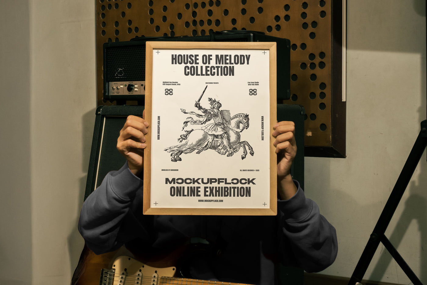 Free Wooden Frame Poster Mockup PSD held by person in Music Studio with Guitar and Amp - MockupFlock