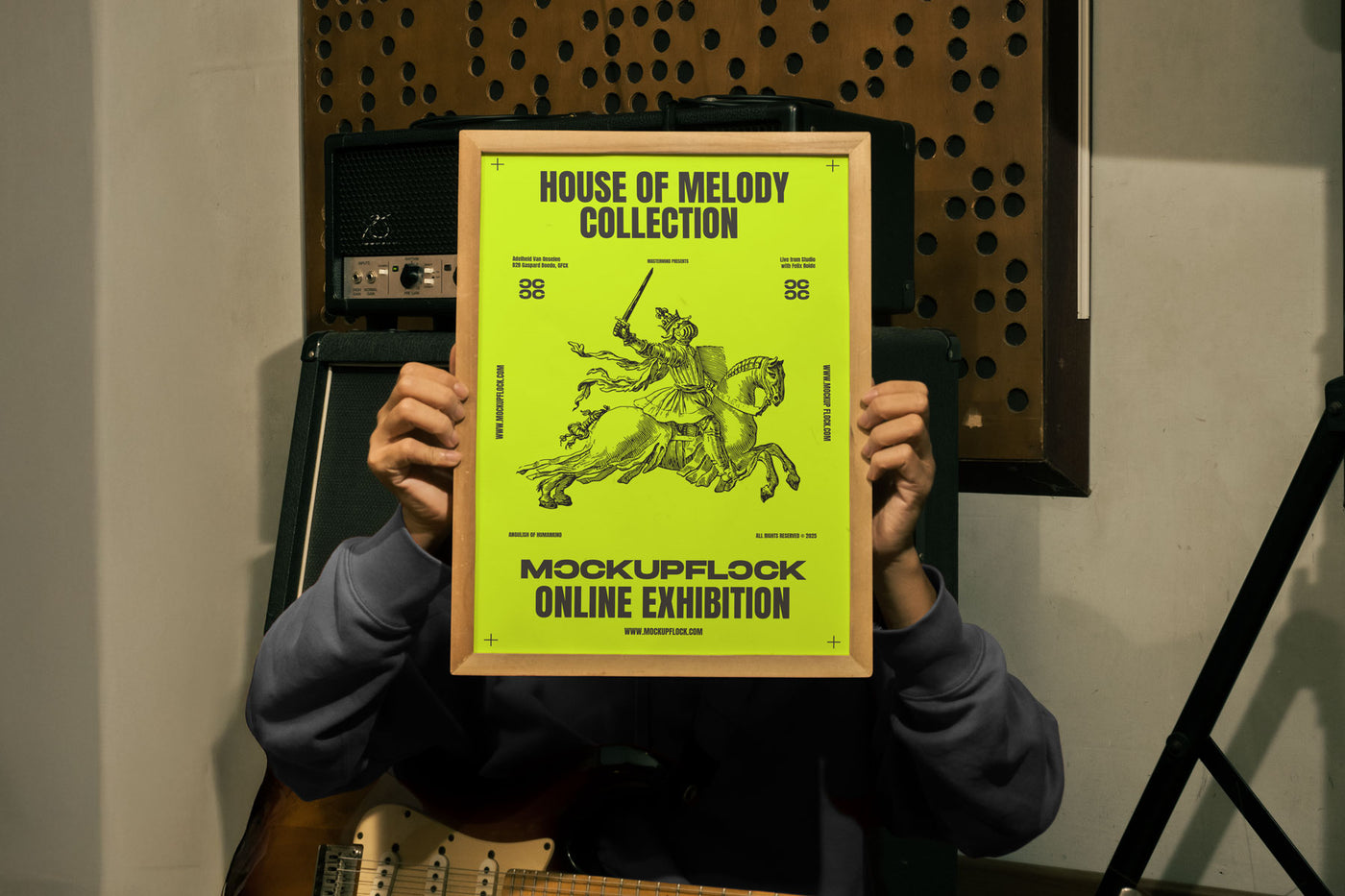 Free Wooden Frame Poster Mockup PSD held by person in Music Studio with Guitar and Amp - MockupFlock