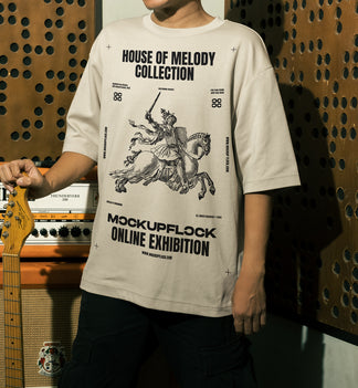 This high quality t-shirt mockup features a person standing in front of an amplifier in a music studio. This aesthetic print mockup was created in Adobe Photoshop.