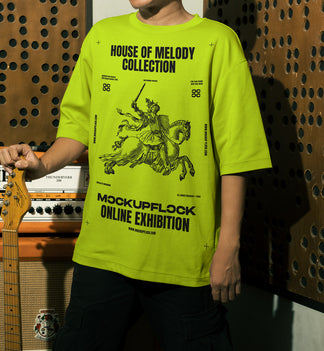 This high quality t-shirt mockup features a person standing in front of an amplifier in a music studio. This aesthetic print mockup was created in Adobe Photoshop.