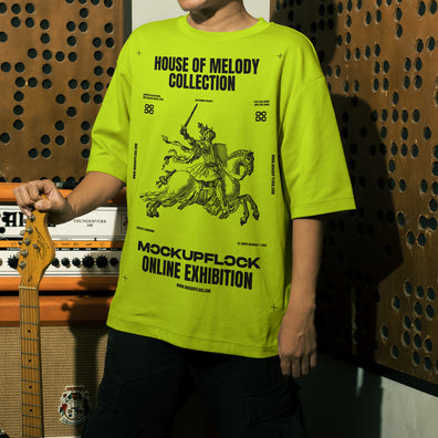 This high quality t-shirt mockup features a person standing in front of an amplifier in a music studio. This aesthetic print mockup was created in Adobe Photoshop.