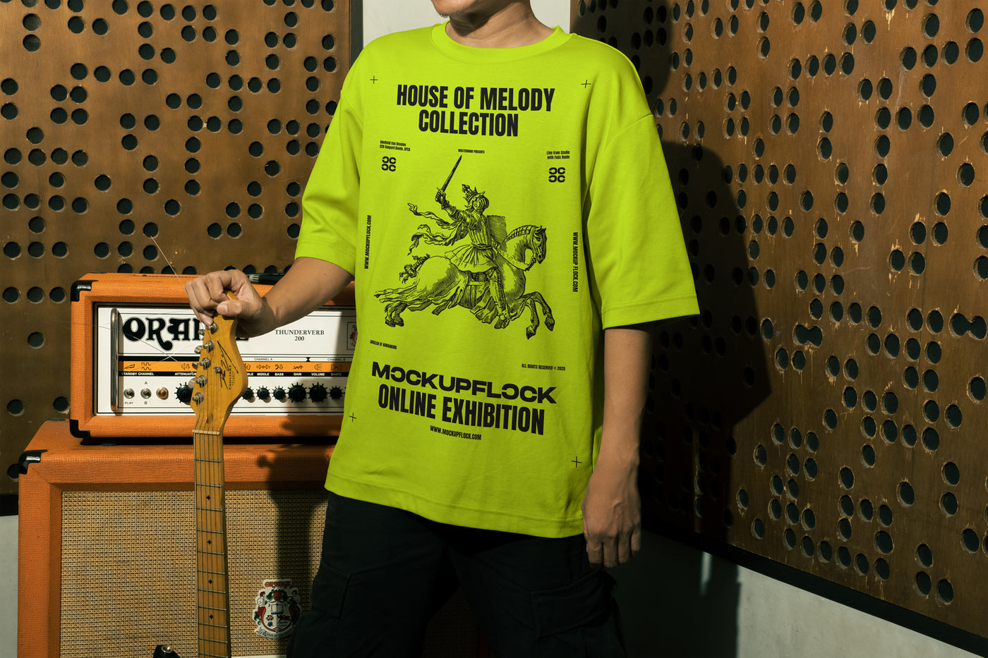 This high quality t-shirt mockup features a person standing in front of an amplifier in a music studio. This aesthetic print mockup was created in Adobe Photoshop.
