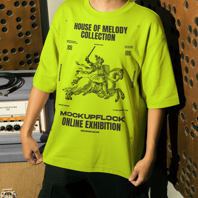This high quality t-shirt mockup features a person standing in front of an amplifier in a music studio. This aesthetic print mockup was created in Adobe Photoshop.