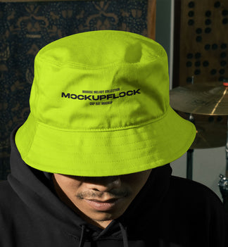 High quality bucket hat mockup of someone wearing a bucket and hoodie in a music studio. Aesthetic print mockup created for Adobe Photoshop