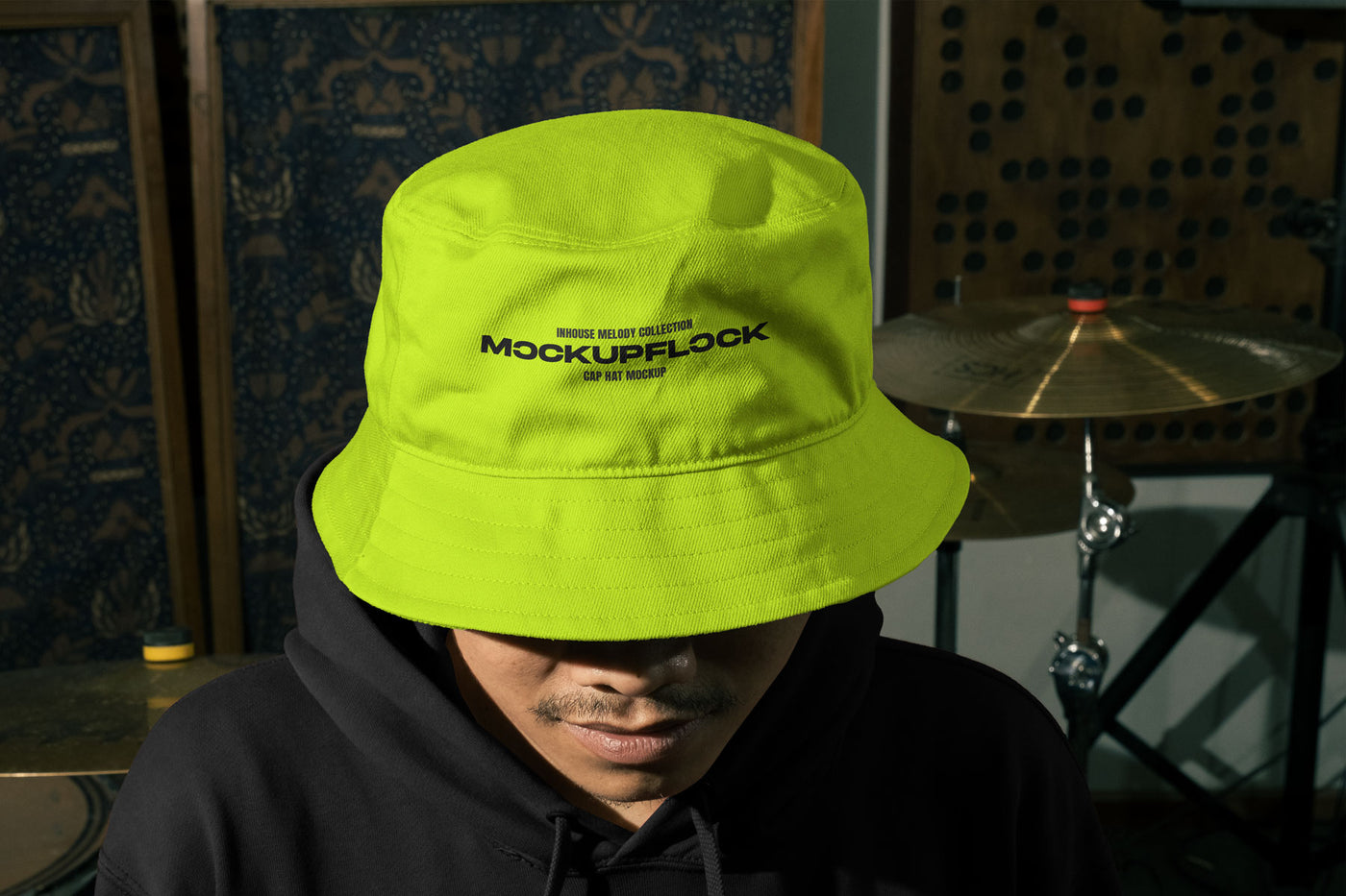 High quality bucket hat mockup of someone wearing a bucket and hoodie in a music studio. Aesthetic print mockup created for Adobe Photoshop
