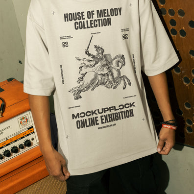 This high-quality t-shirt mockup features a person standing in front of an orange amplifier in a music studio. This aesthetic print mockup was created in Adobe Photoshop.