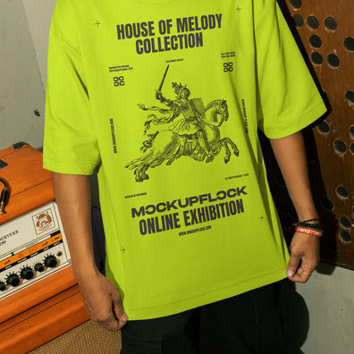 This high-quality t-shirt mockup features a person standing in front of an orange amplifier in a music studio. This aesthetic print mockup was created in Adobe Photoshop.