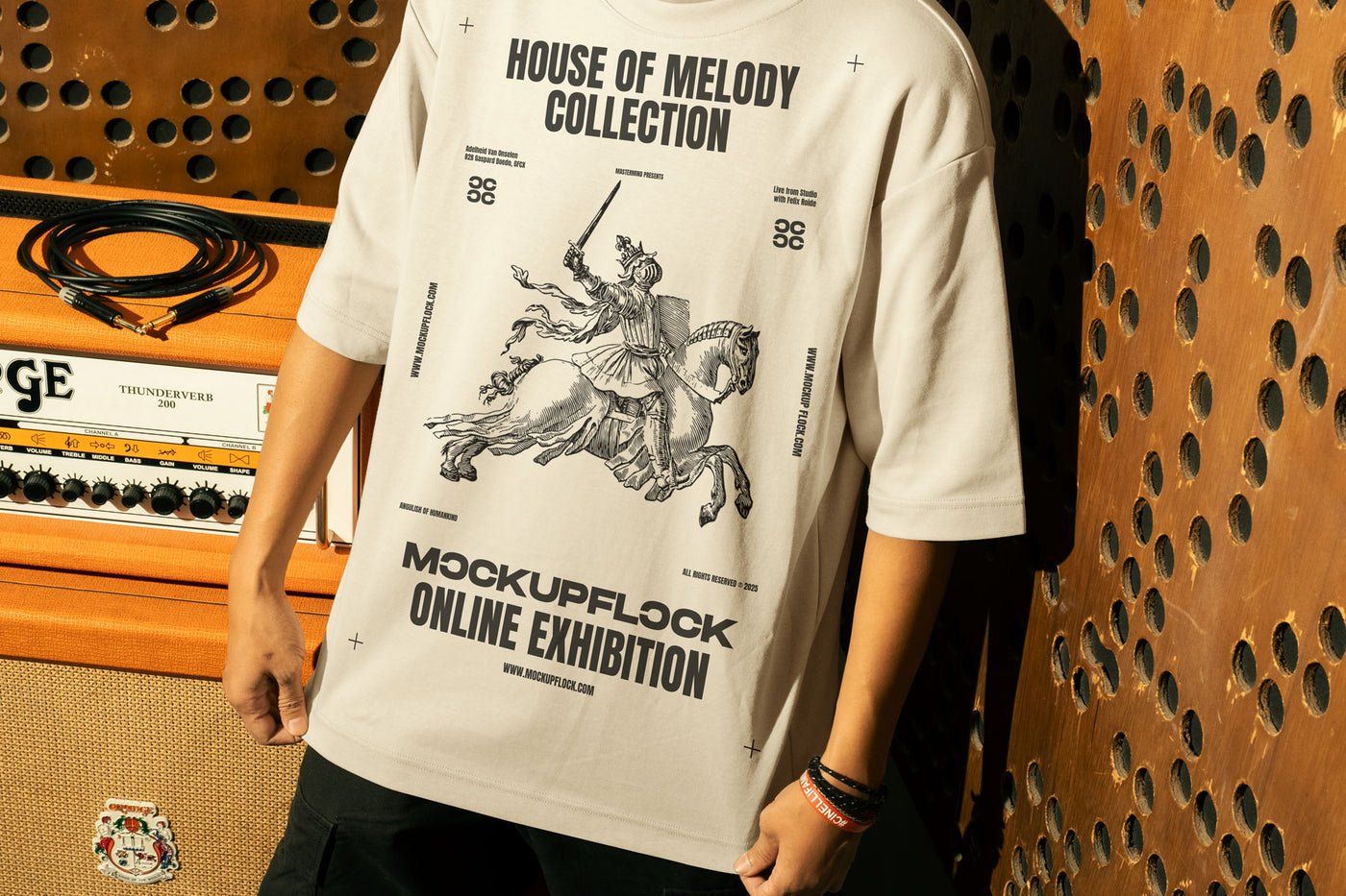 This high-quality t-shirt mockup features a person standing in front of an orange amplifier in a music studio. This aesthetic print mockup was created in Adobe Photoshop.