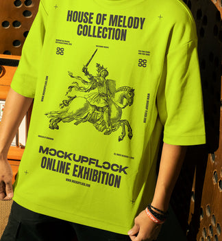 This high-quality t-shirt mockup features a person standing in front of an orange amplifier in a music studio. This aesthetic print mockup was created in Adobe Photoshop.
