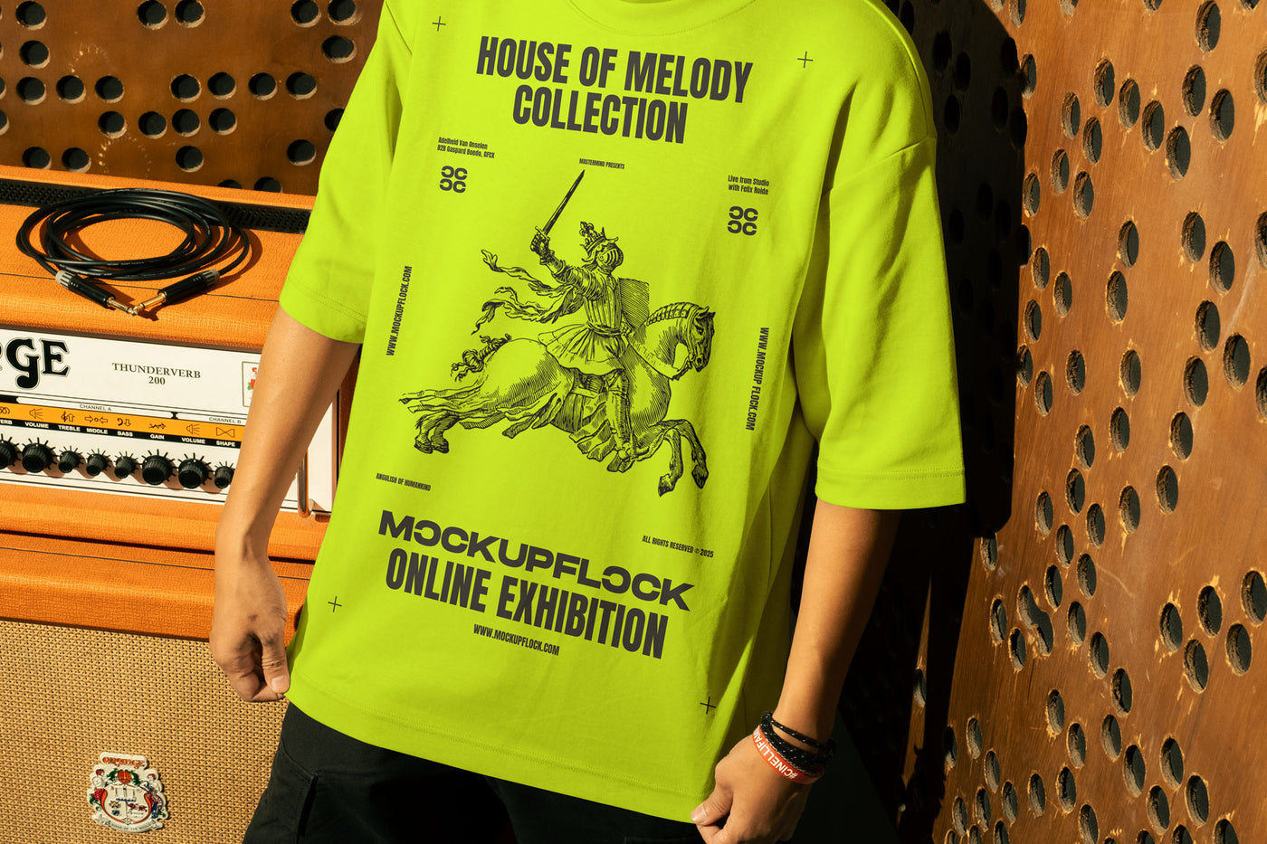 This high-quality t-shirt mockup features a person standing in front of an orange amplifier in a music studio. This aesthetic print mockup was created in Adobe Photoshop.