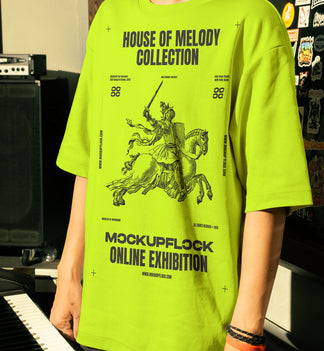 This high-quality t-shirt mockup features a person standing in front of an orange amplifier in a music studio. This aesthetic print mockup was created in Adobe Photoshop.