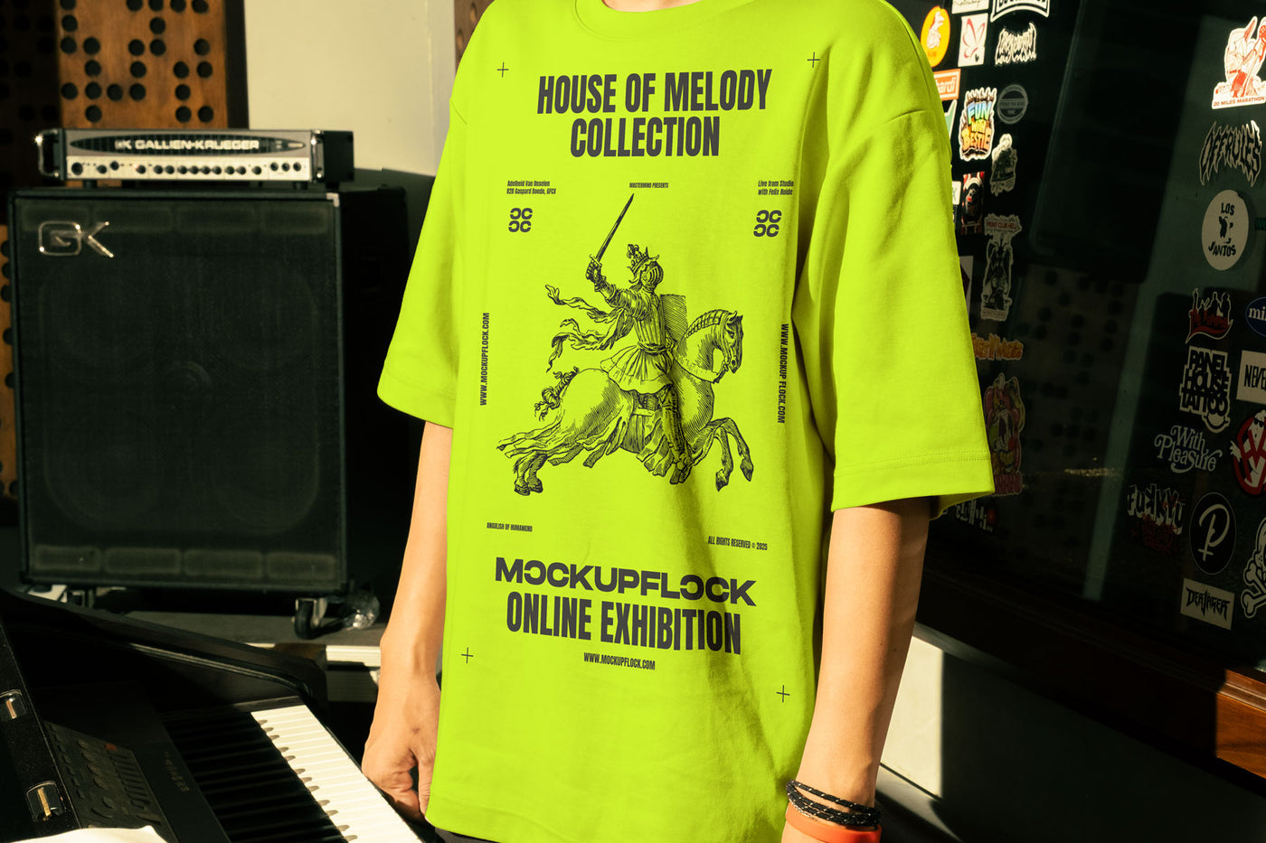 This high-quality t-shirt mockup features a person standing in front of an orange amplifier in a music studio. This aesthetic print mockup was created in Adobe Photoshop.
