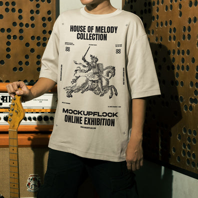 This high quality t-shirt mockup features a person standing in front of an amplifier in a music studio. This aesthetic print mockup was created in Adobe Photoshop.