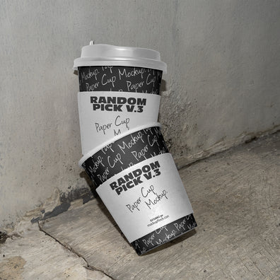 stacked urban paper cups mockup with text design on a realistic concrete floor against a gray wall