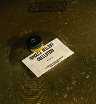 business card mockup leaning on a cymbal drums