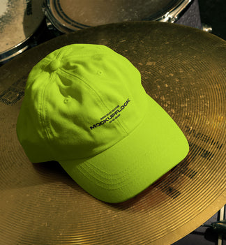 cap hat mockup leaning on a cymbal drums