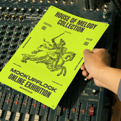 hand holding a poster a4 mockup over an analog mixer